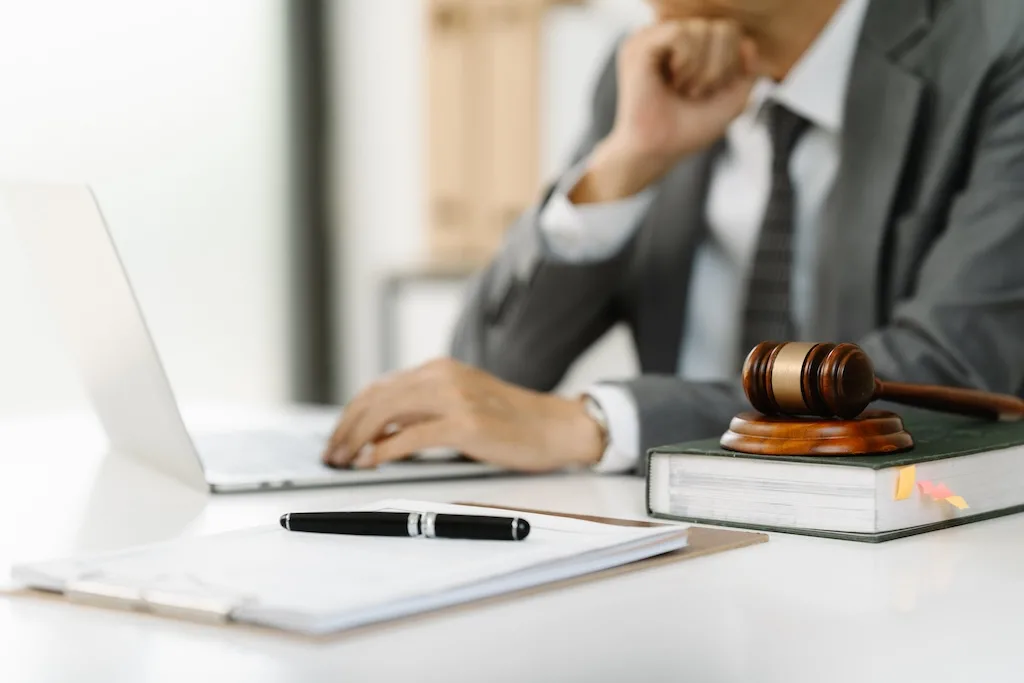 Lawyer Working On Laptop With Gavel Lawyer Working On Laptop With Gavel